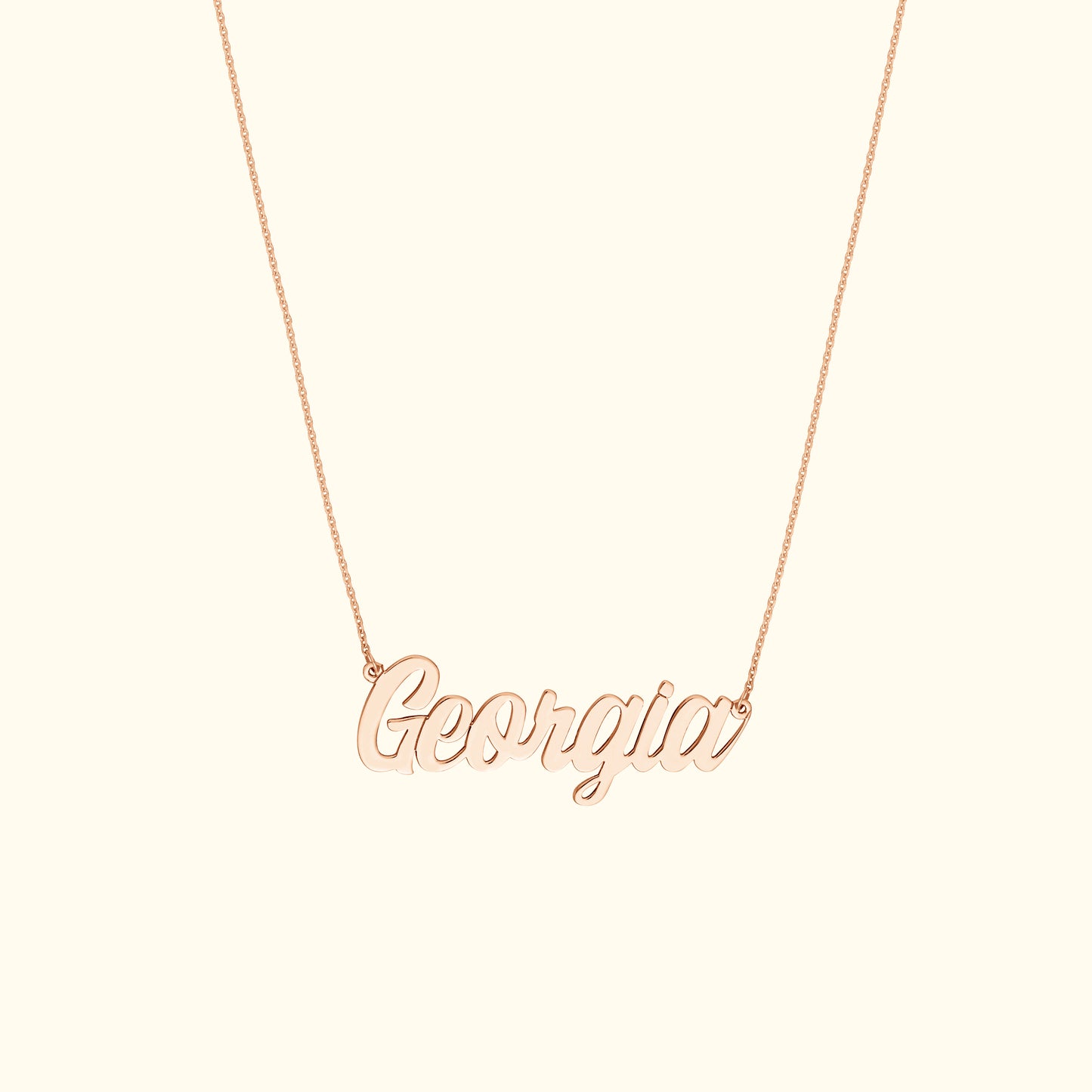 Rose gold name necklace spelling "Georgia" on a delicate chain.