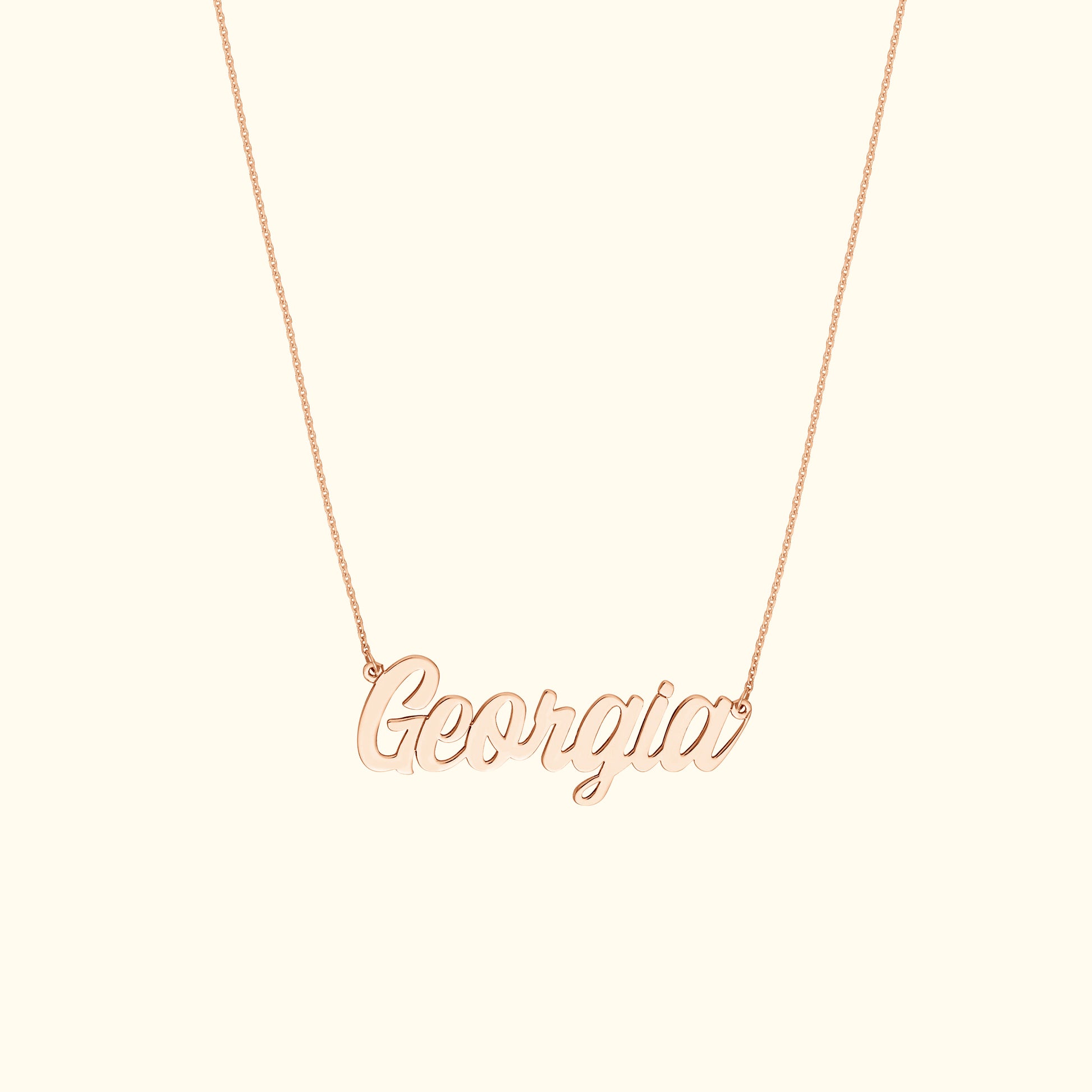 Rose gold name necklace spelling "Georgia" on a delicate chain.