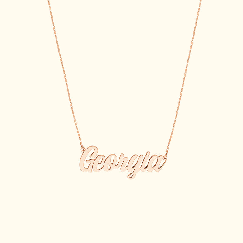 Rose gold name necklace spelling "Georgia" on a delicate chain.