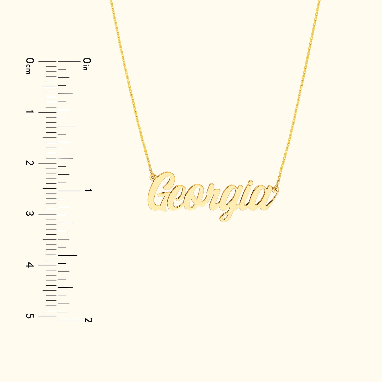 Gold name necklace depicting "Georgia" against a neutral background with a measurement scale.