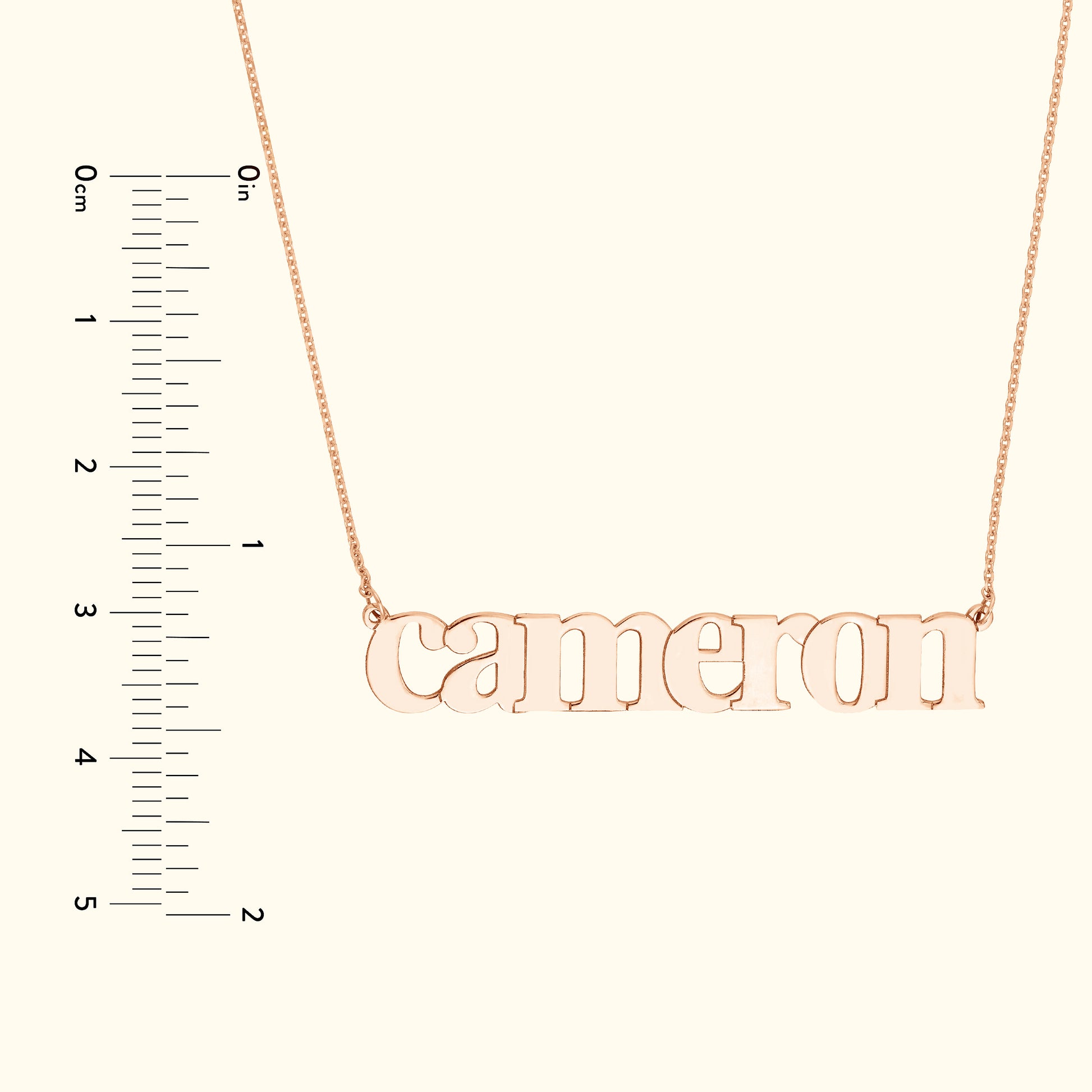 Rose gold name necklace with the word "cameron" displayed prominently.