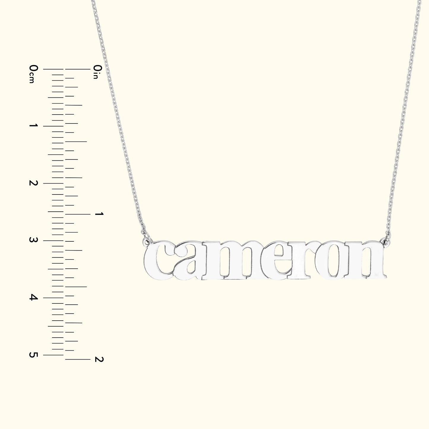 Silver name necklace displaying "Cameron" with a ruler for size reference.