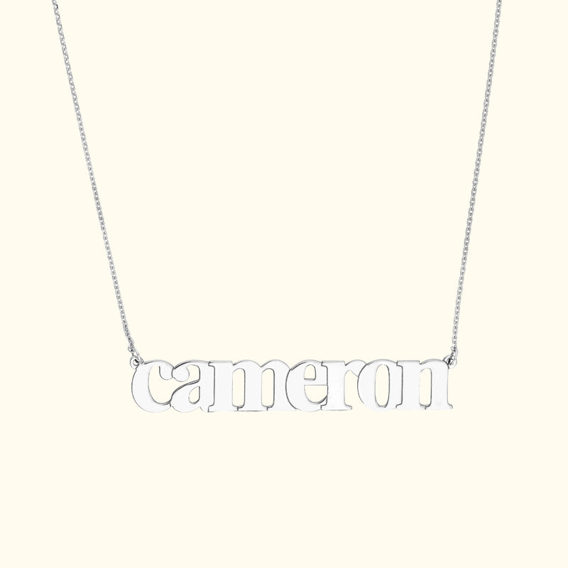 Silver name necklace featuring the word "cameron" in lowercase letters.