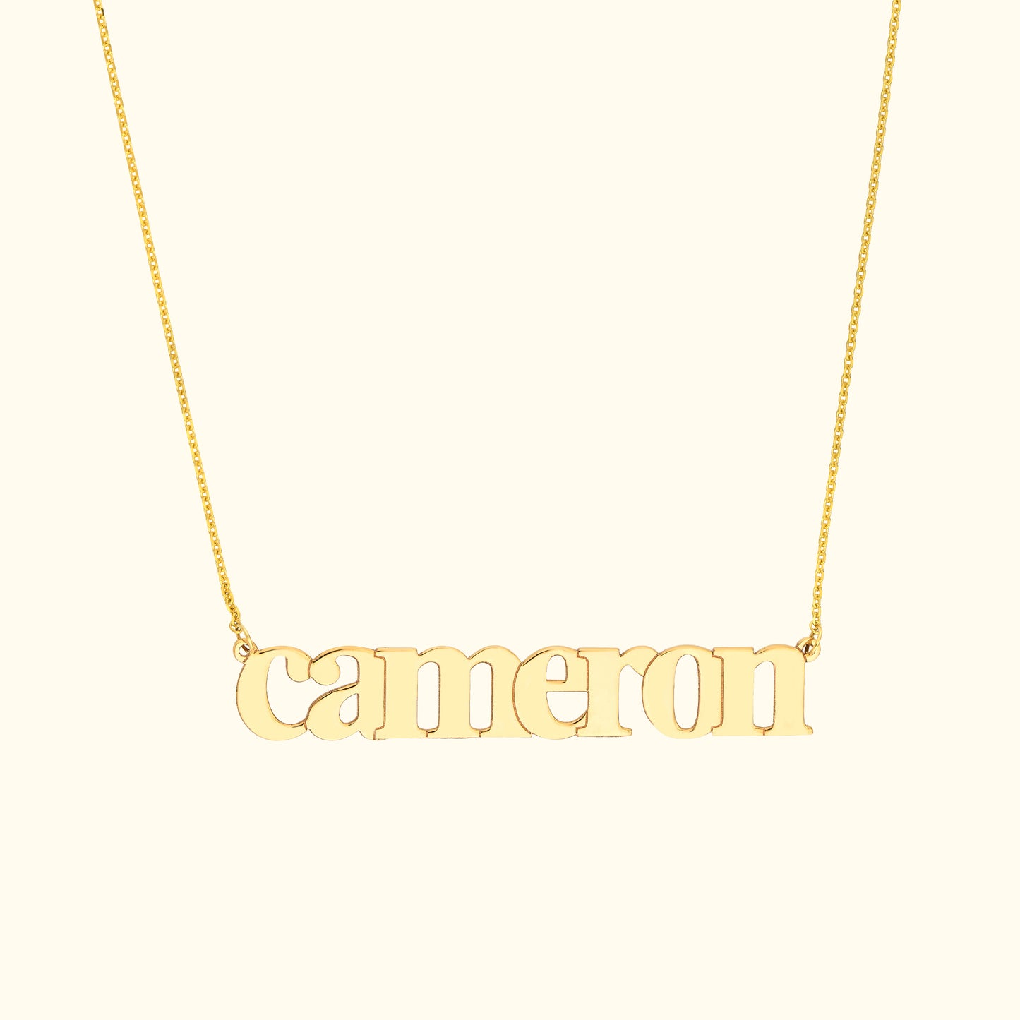 Gold name necklace featuring the word "cameron" in a stylish font.