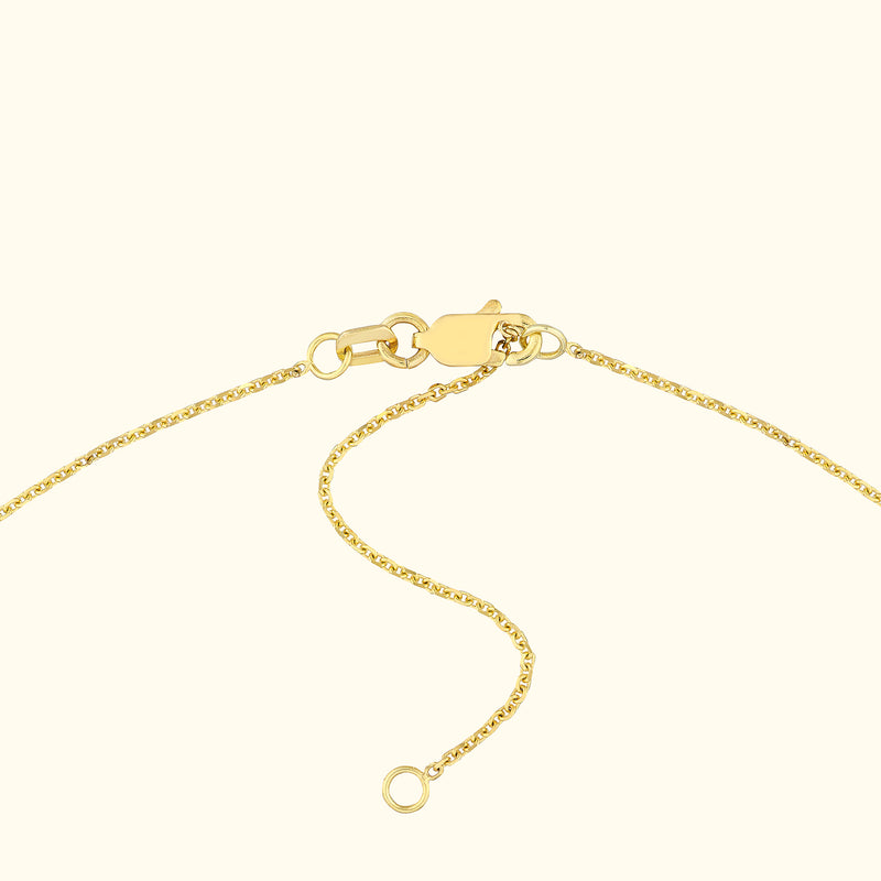 Close-up of a gold chain necklace with a lobster clasp and adjustable length.