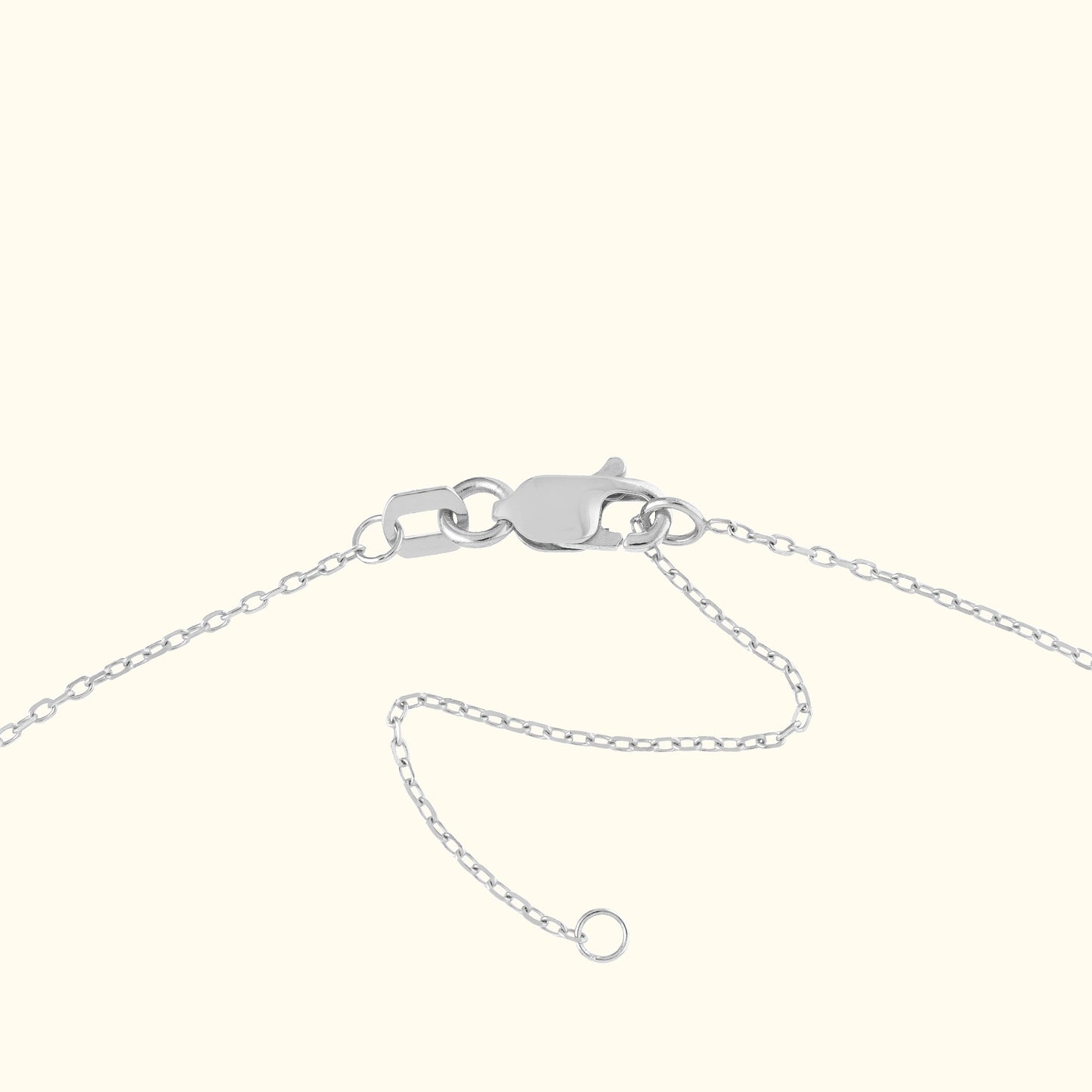 Silver bracelet clasp with a chain, against a neutral background.