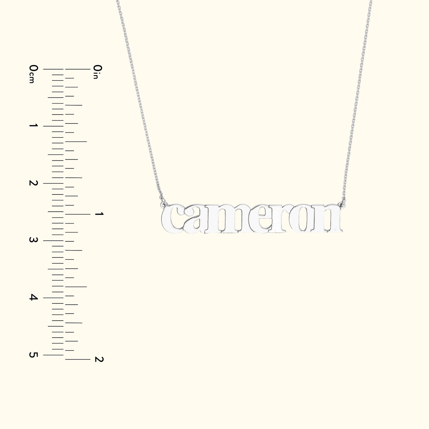 Silver name necklace spelling "Cameron" on a simple chain, with a measuring scale on the side.