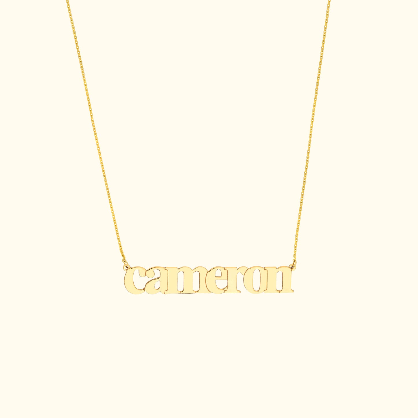 Gold necklace featuring the name "cameron" in a decorative font.