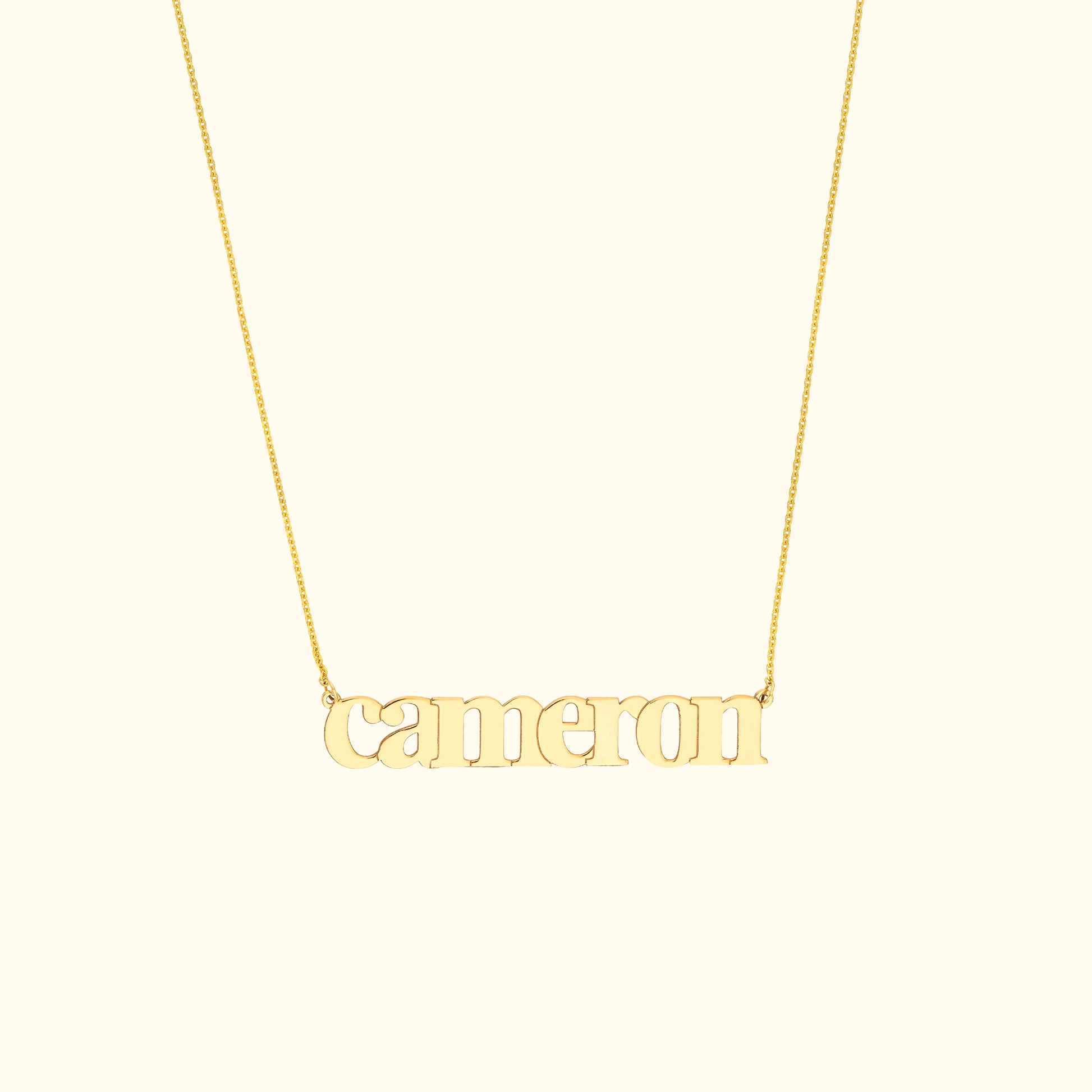 Gold necklace featuring the name "cameron" in a decorative font.