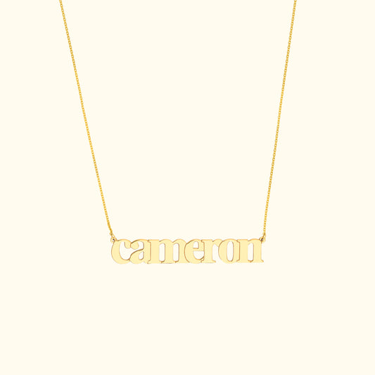 Gold necklace featuring the name "cameron" in a decorative font.