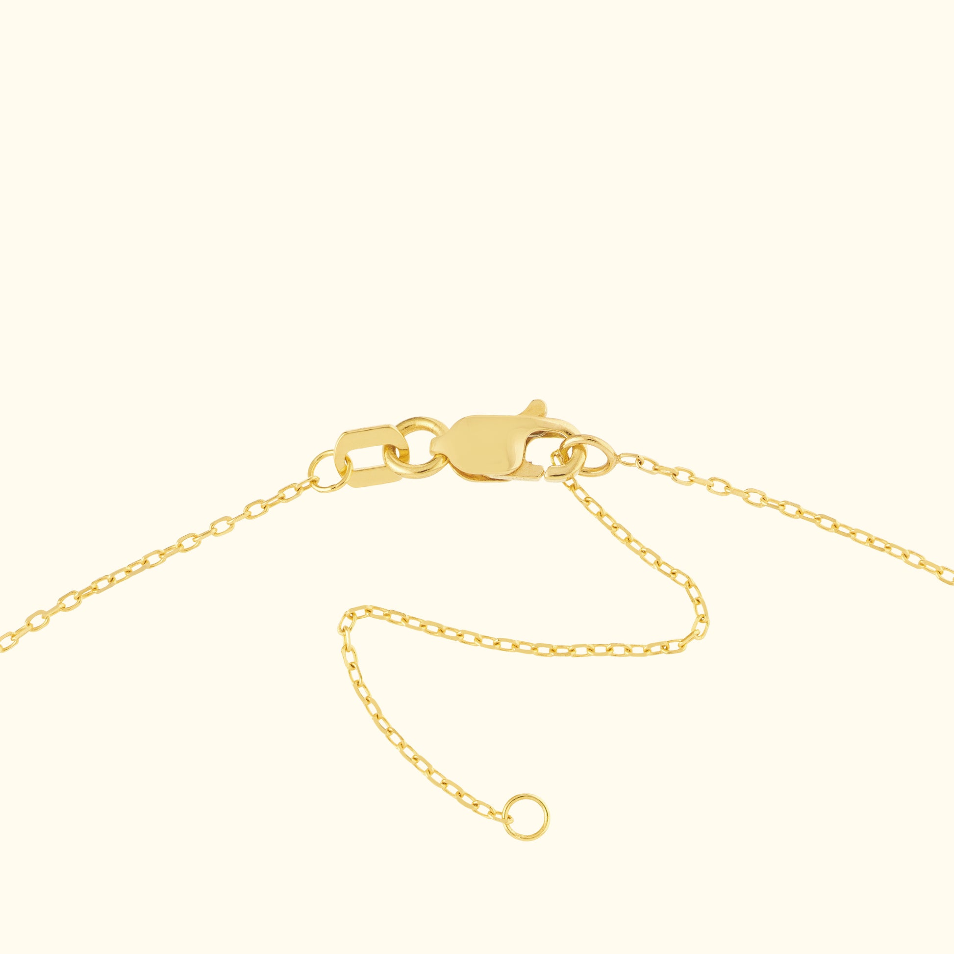 Close-up of a gold chain bracelet clasp with a fine chain.