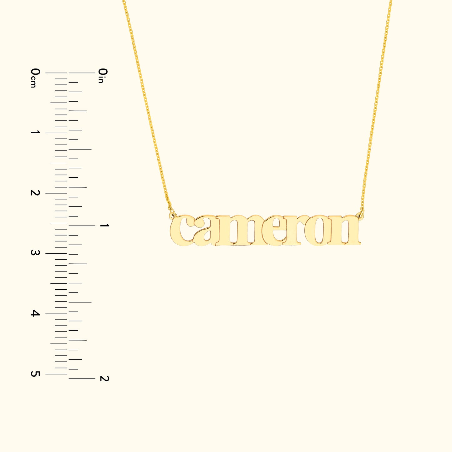 Gold name necklace featuring the name "Cameron" with a ruler for size reference.