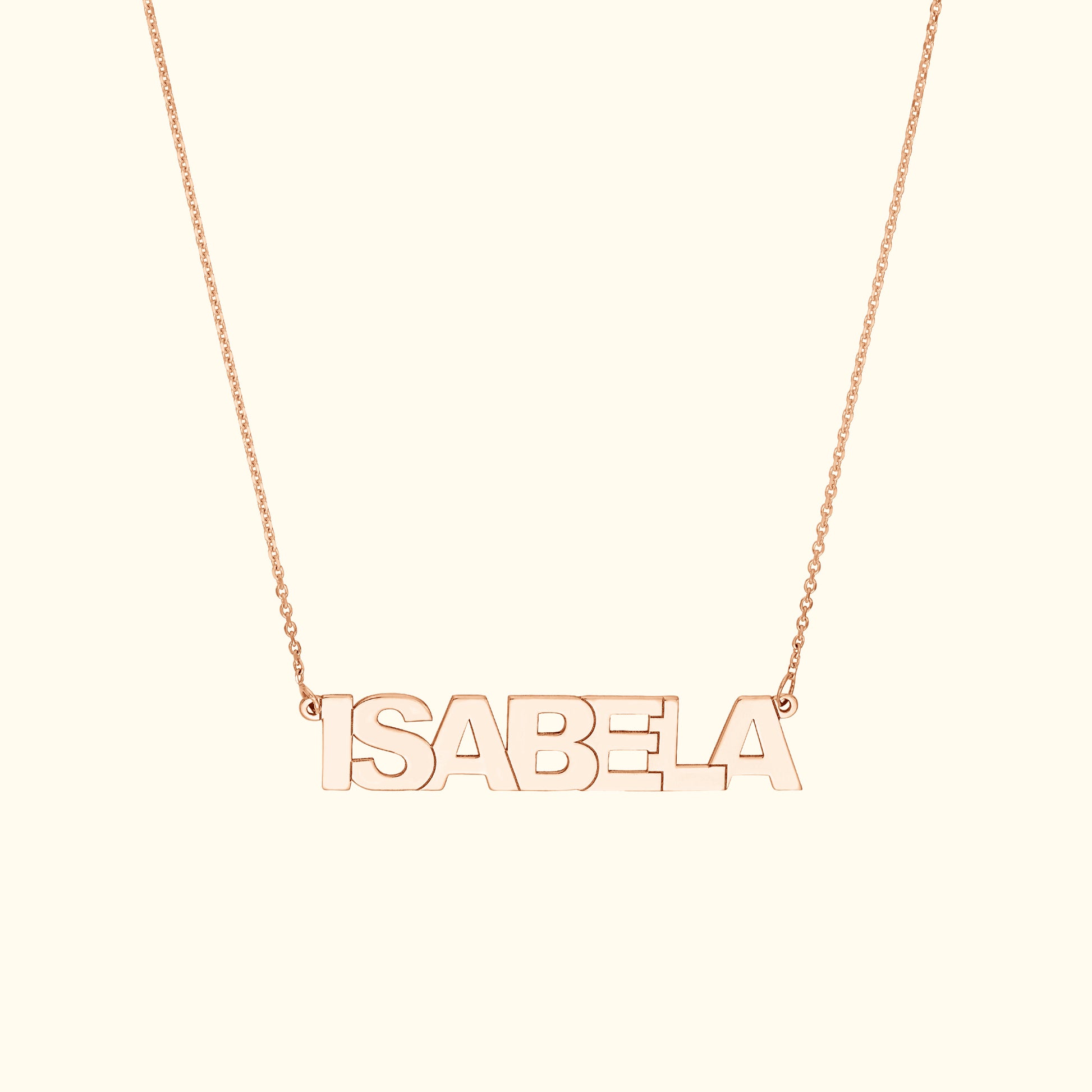 Rose gold name necklace spelling "ISABELA" on a delicate chain.