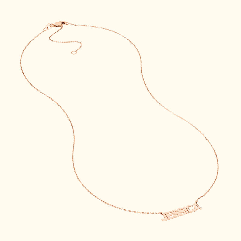 Personalized rose gold necklace with the name "Jessica" in elegant lettering.