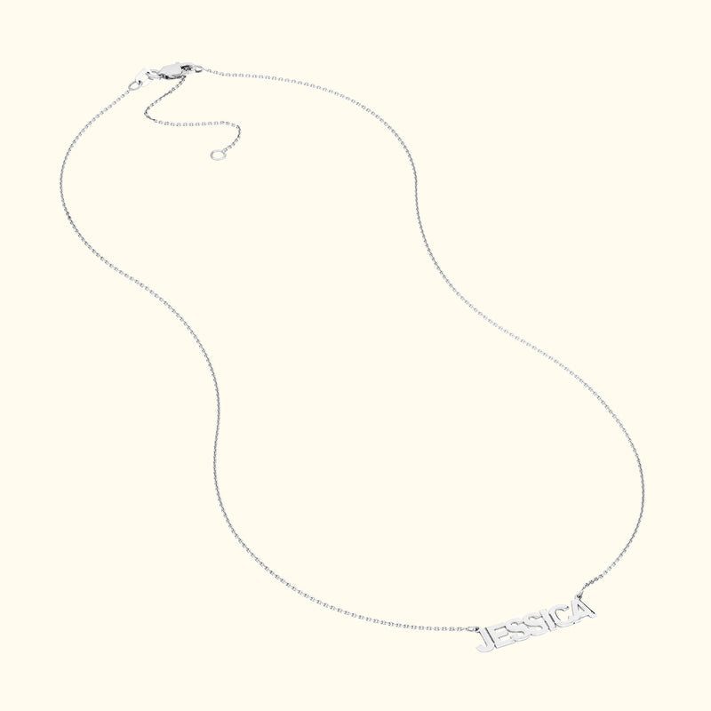 Silver necklace with a chain and personalized name "JESSICA" as the centerpiece.