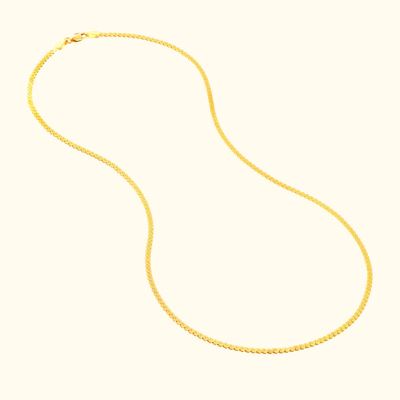 Sleek gold chain necklace displayed against a light background.