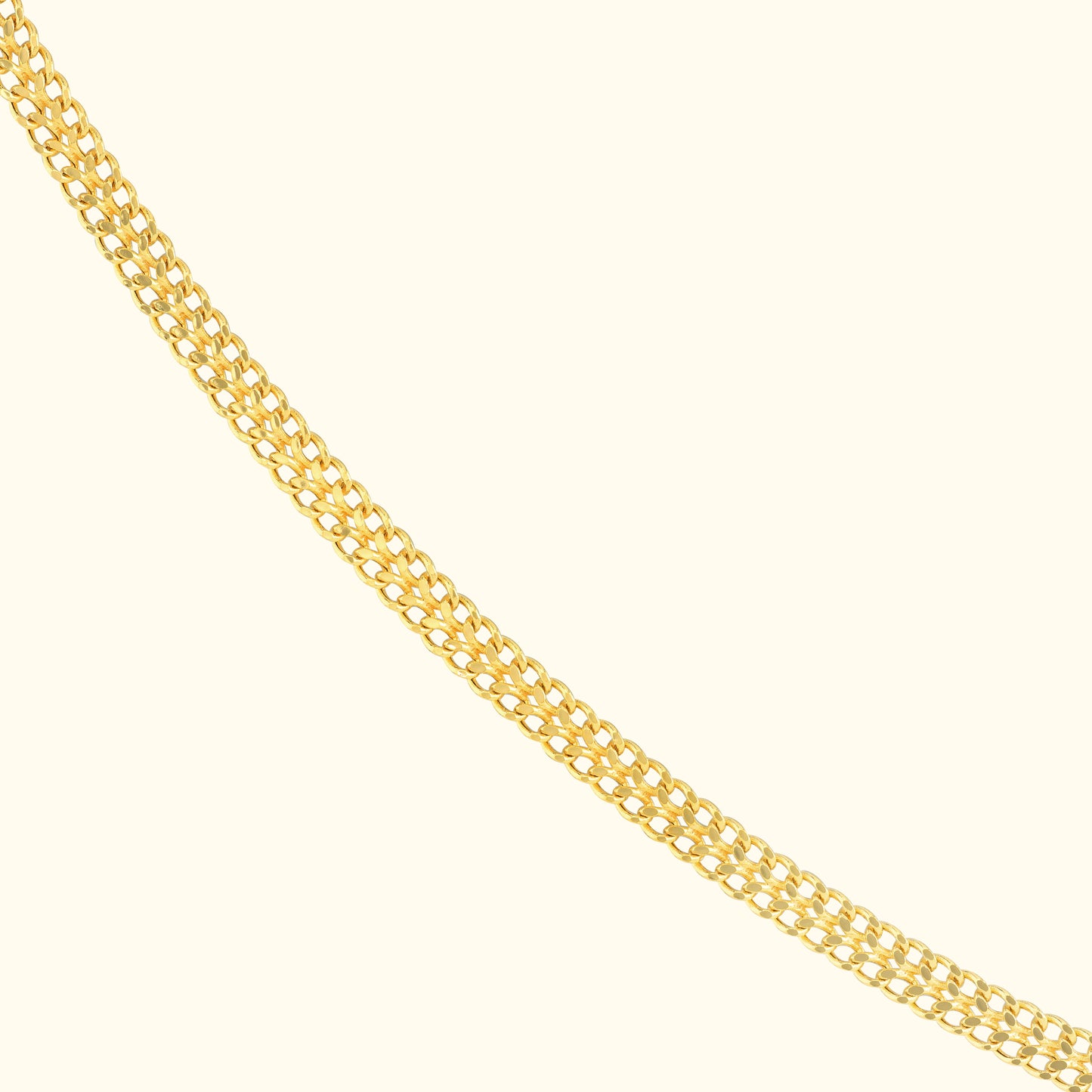 A shiny gold chain with interlocking links displayed on a light background.