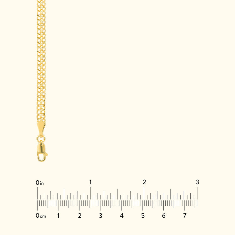 Golden chain necklace with a lobster clasp, displayed with a measurement ruler below.