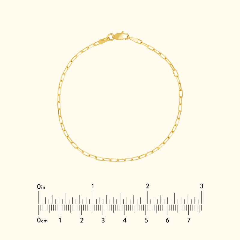 Delicate gold chain bracelet with a lobster clasp, displayed on a light background.