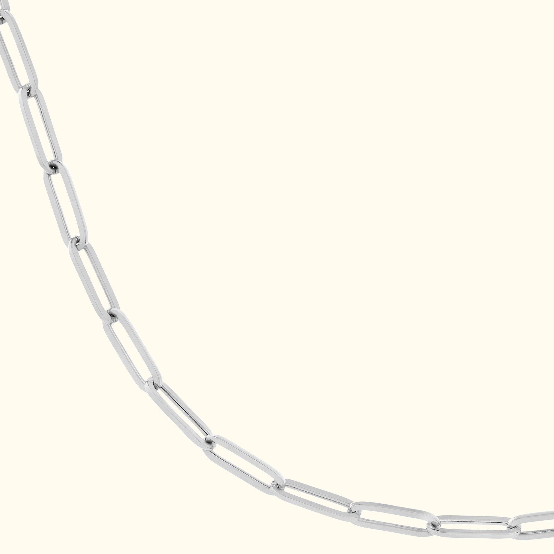Silver link necklace with elongated oval links on a light background.