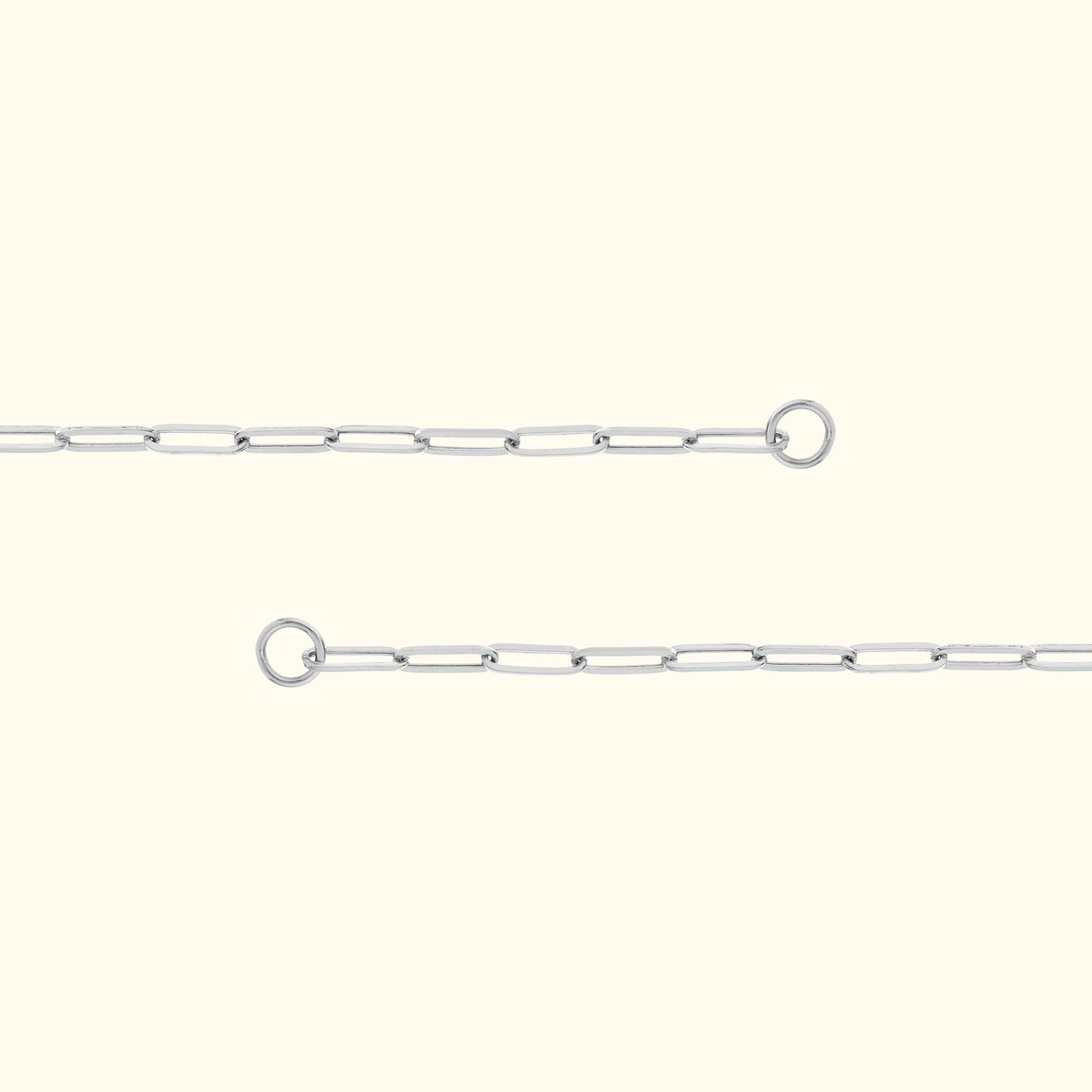 Delicate silver link chain with connection rings on either end, set against a light background.