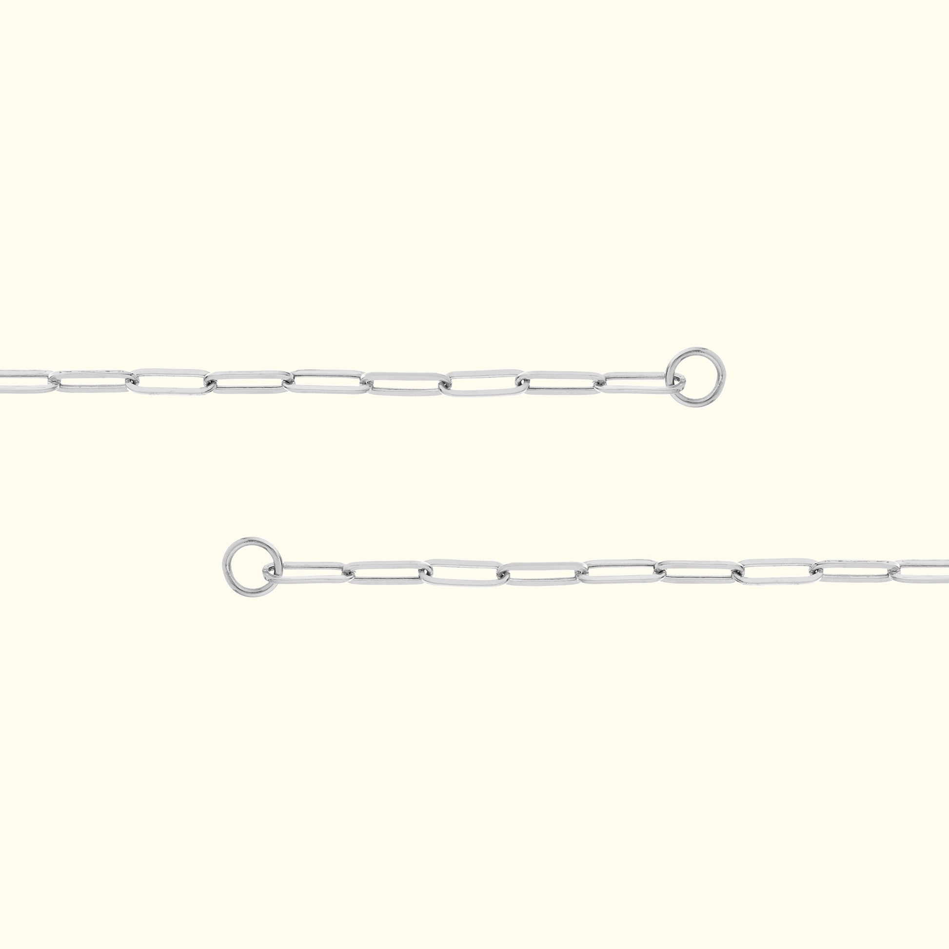 Delicate silver link chain with connection rings on either end, set against a light background.