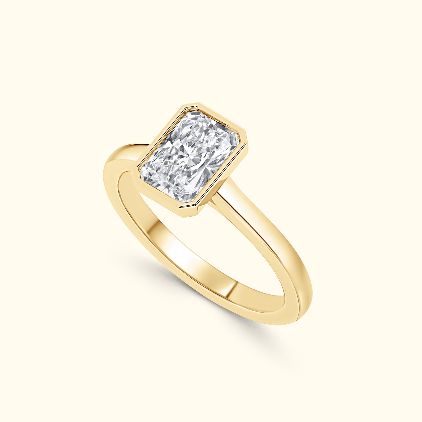 A gold ring featuring a rectangular diamond set in a simple band.