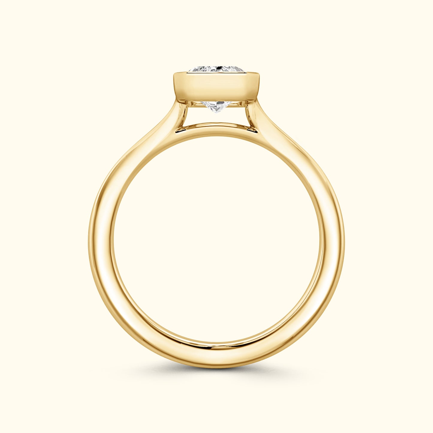 Solitaire gold engagement ring with a round diamond setting.