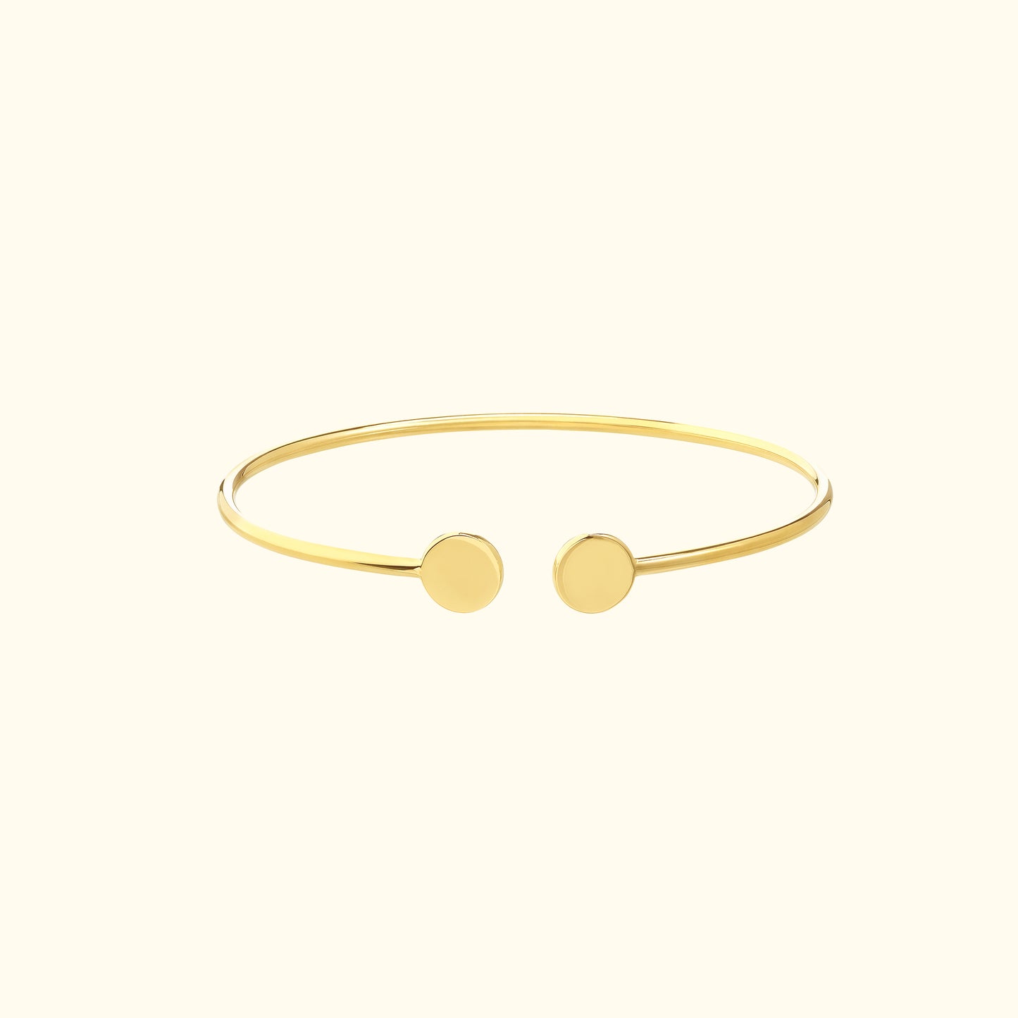 Minimalist gold cuff bracelet with two round ends.