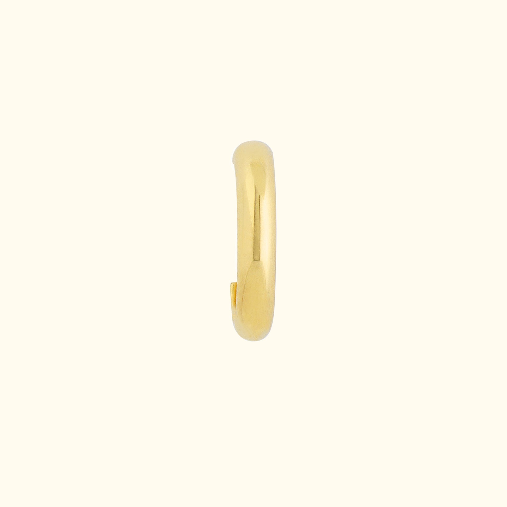 Gold hoop earring with a sleek, smooth design on a light background.