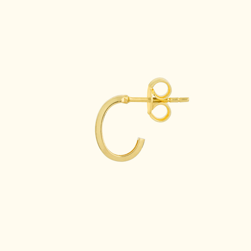 Minimalist gold hoop earring with a secure back.