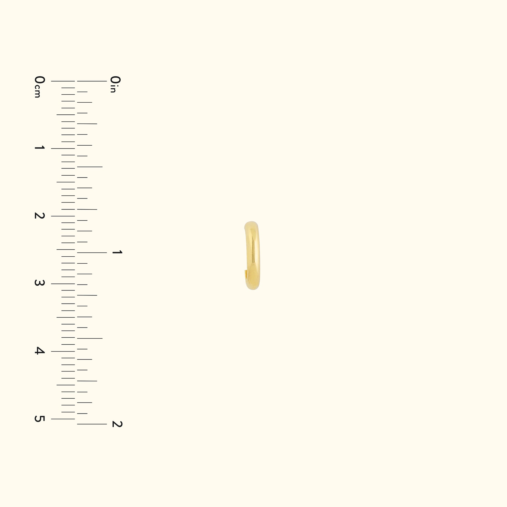 Small, simple gold hoop earring displayed next to a ruler for size comparison.