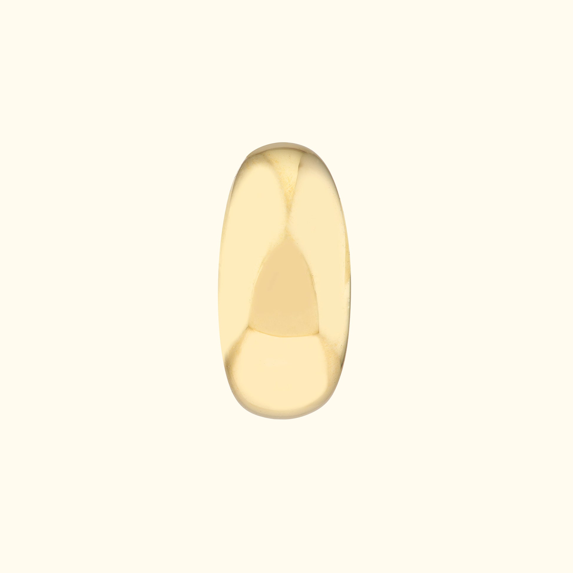 Smooth, polished gold ring with an oval shape against a light background.