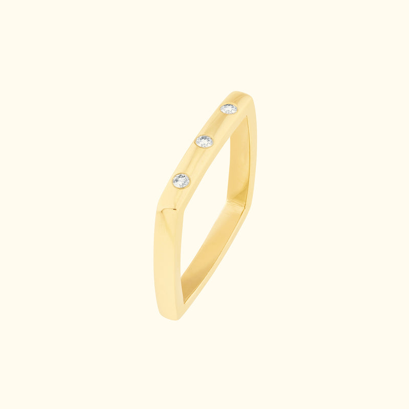 Yellow gold ring with three small diamonds set in a modern, angular design.