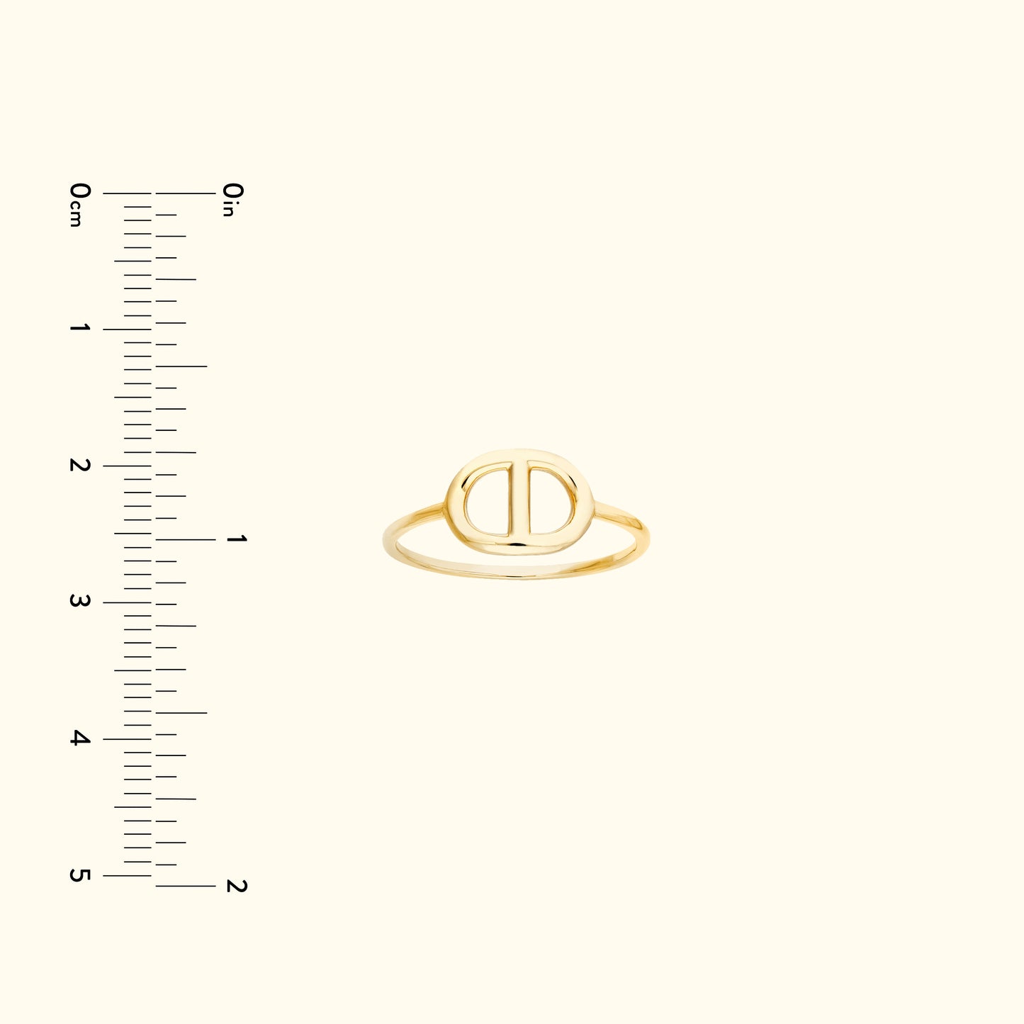 Simple gold ring with an oval design, placed against a light background with a ruler.