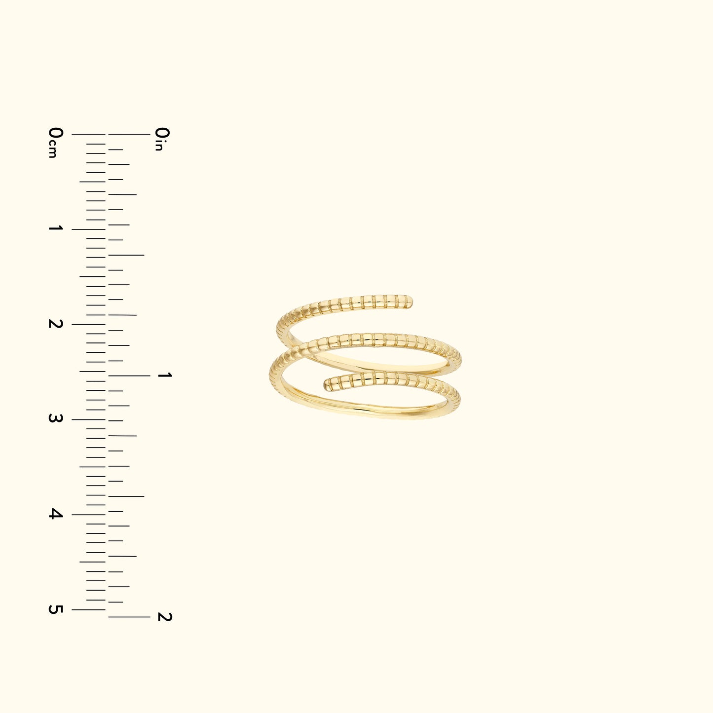 Gold spiral ring displayed next to a ruler for size reference.