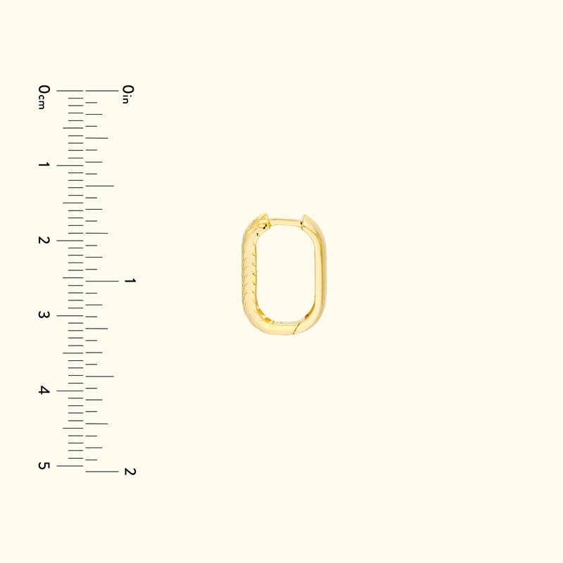 Gold oval-shaped jewelry connector with a textured edge on a light background.