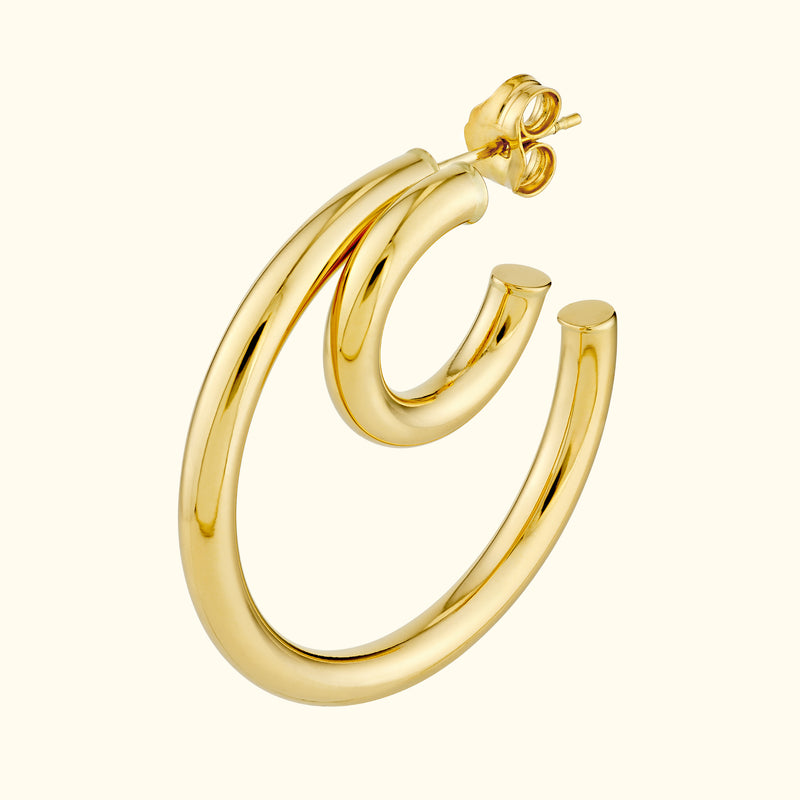 Polished gold hoop earrings with a curved design, showcasing a modern style.