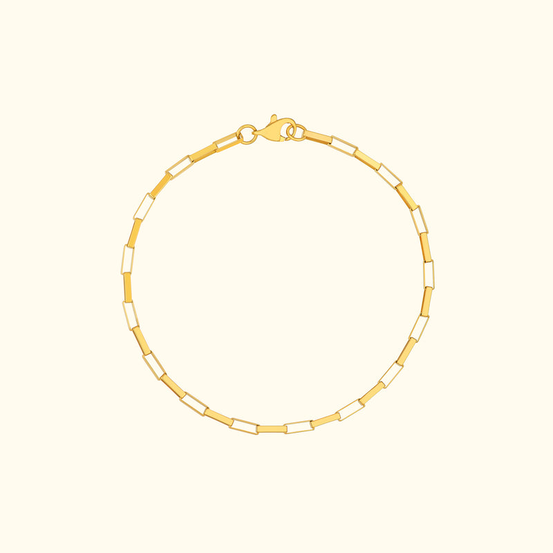 Gold chain bracelet with alternating rectangular links and a lobster clasp.