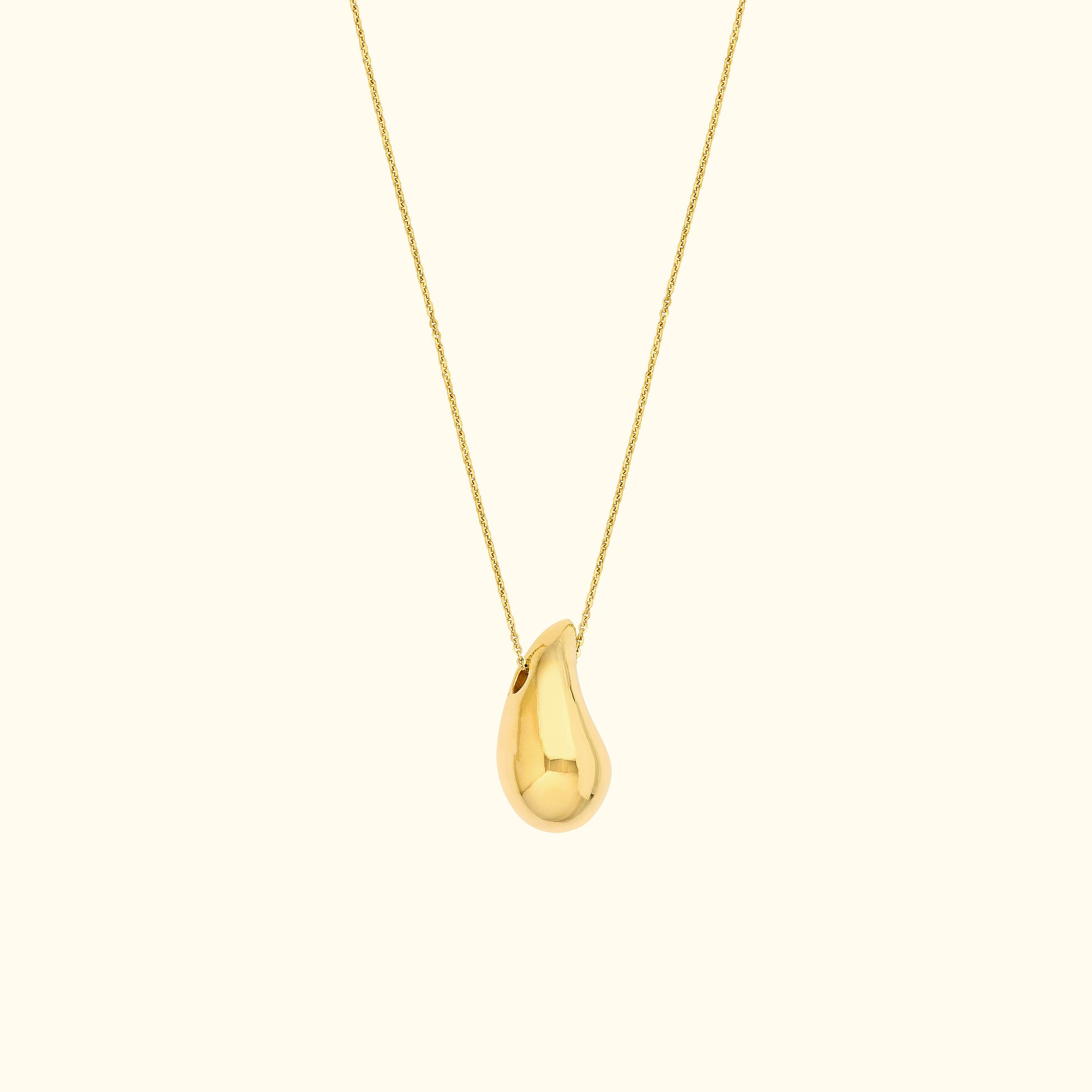 Gold pendant necklace with a teardrop-shaped charm on a delicate chain.
