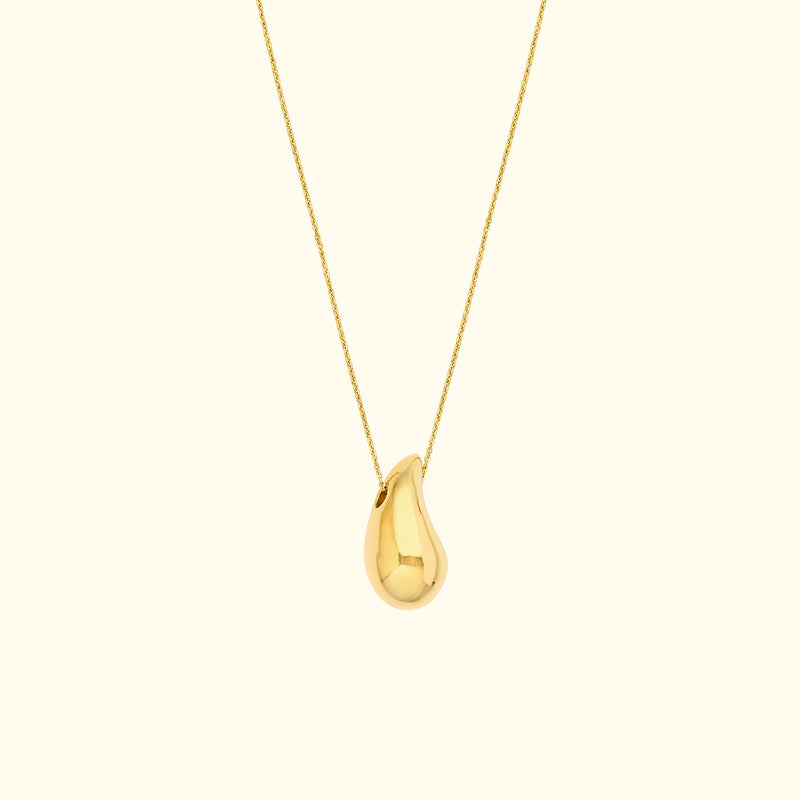 Gold pendant necklace with a teardrop-shaped charm on a delicate chain.