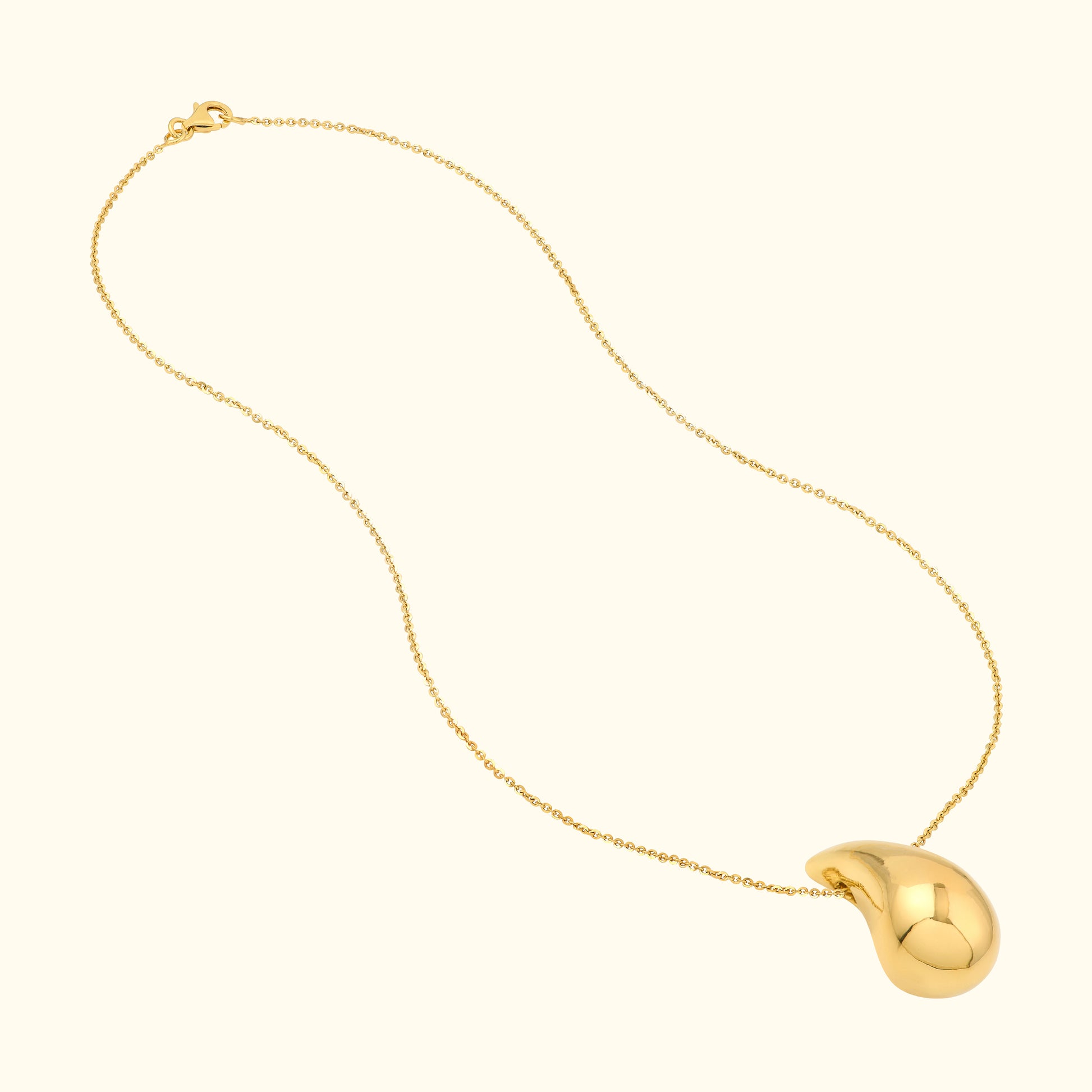 Sleek gold necklace with a polished teardrop-shaped pendant.