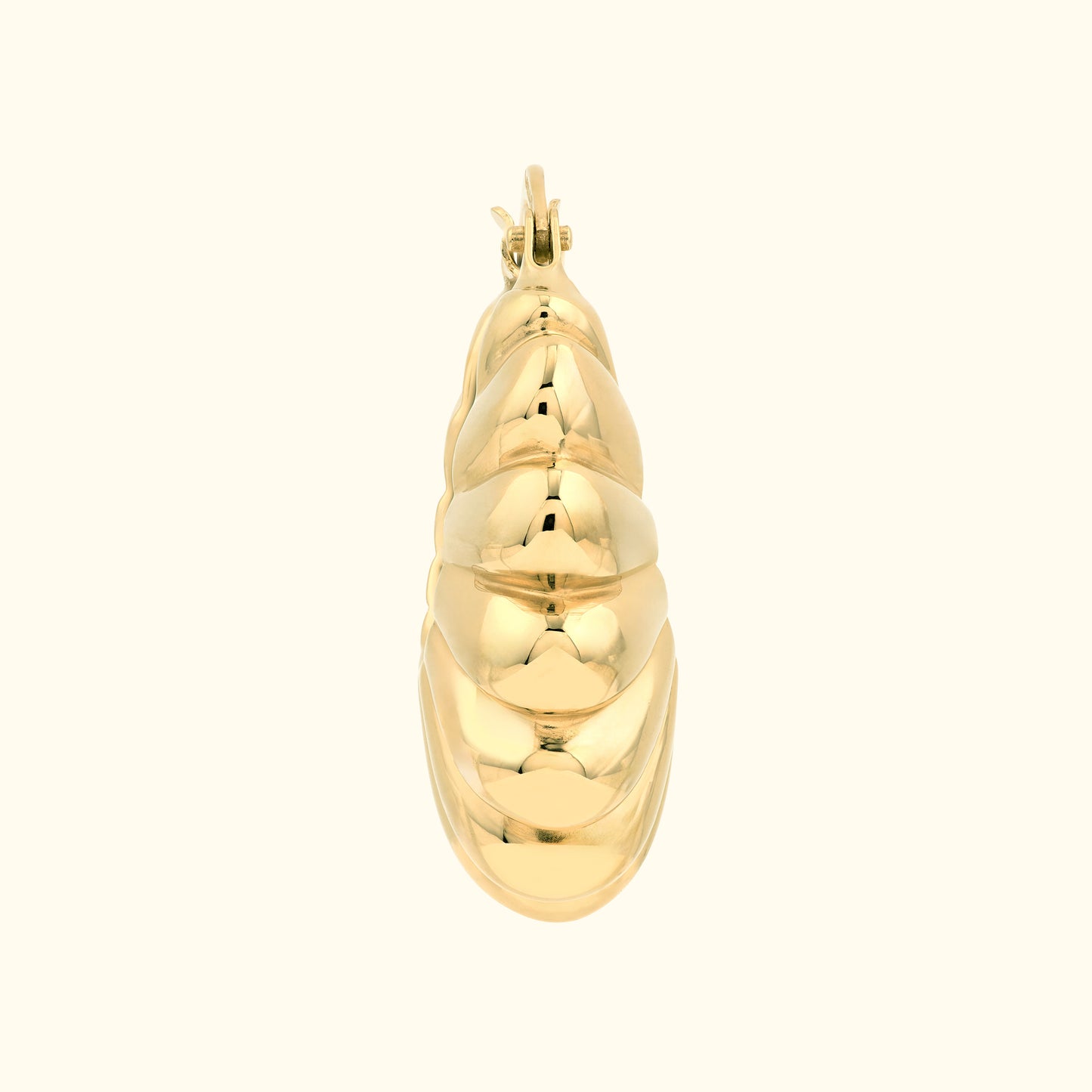 Gold earring with a smooth, spiraling design.