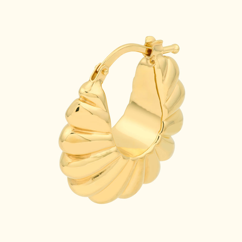 Gold spiral hoop earring with a textured shell design.