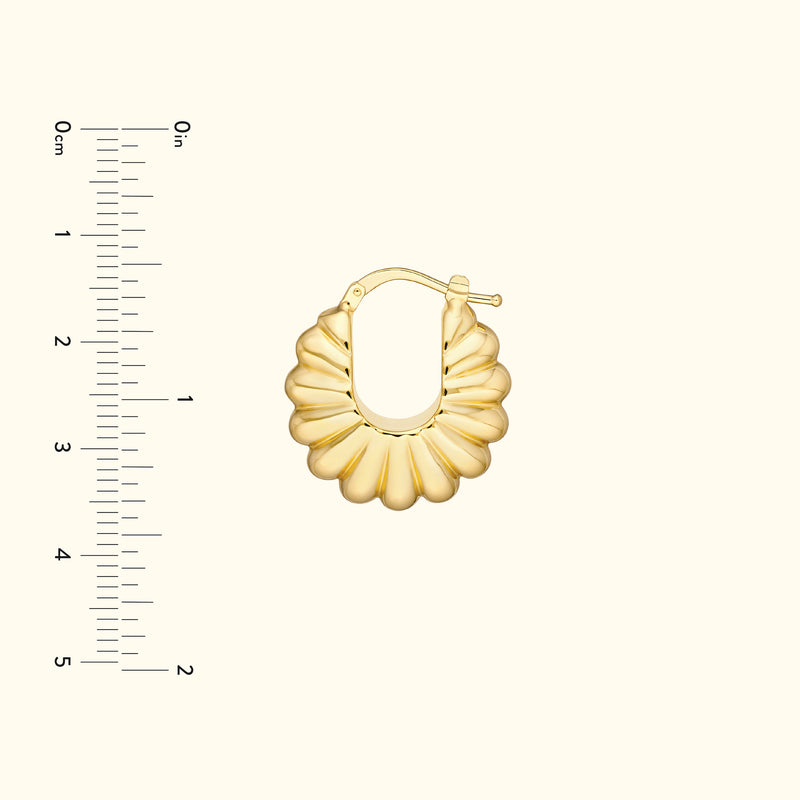 Gold hoop earring with a scalloped design, displayed alongside a measurement ruler.