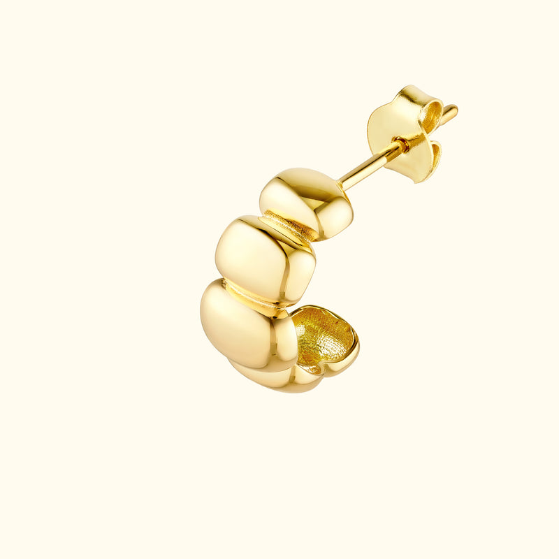 Gold hoop earring with smooth, rounded accents on the front.