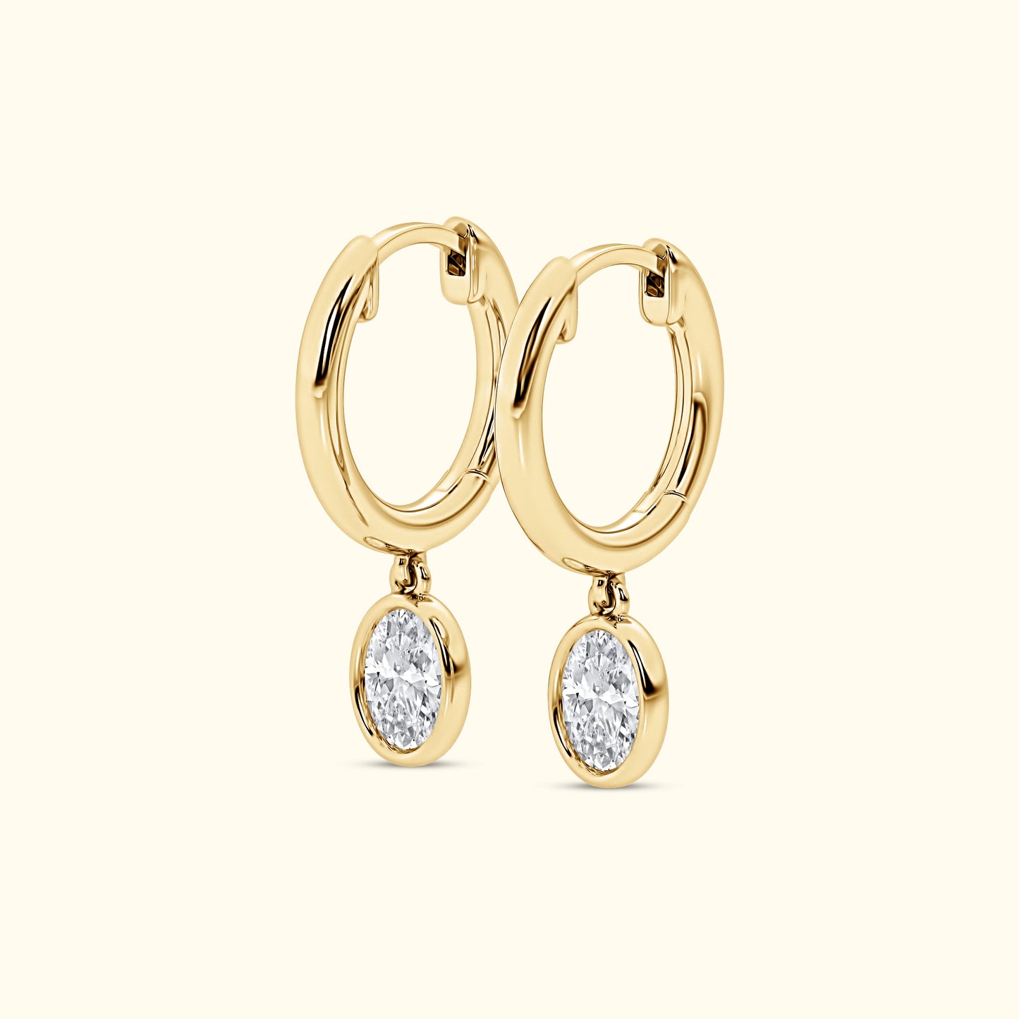 Yellow gold Huggie with a Bezel Set Oval Diamond Drop