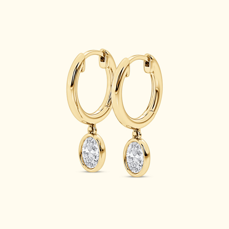 Yellow gold Huggie with a Bezel Set Oval Diamond Drop