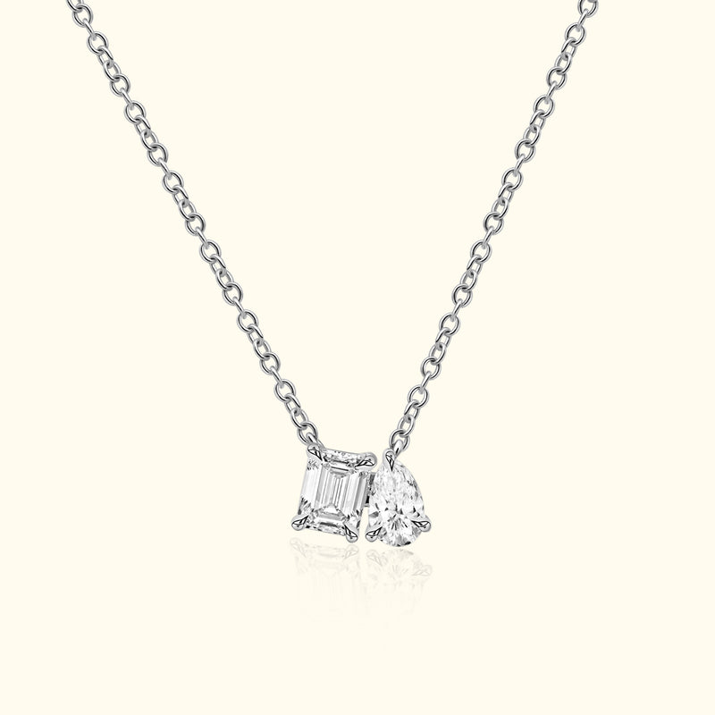 Silver necklace featuring two distinct diamond charms.