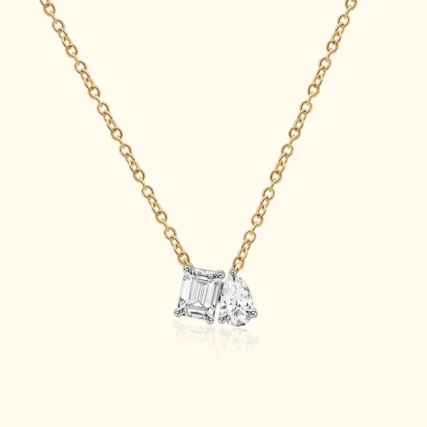 Gold chain necklace featuring two sparkling diamond charms.